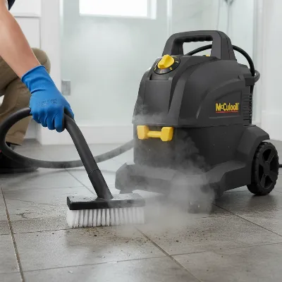 McCulloch MC1385 Deluxe Canister Steam Cleaner, a large black and yellow unit, cleaning stained floor grout with a utility brush.