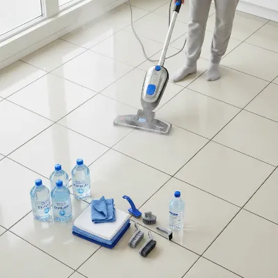 Person using a steam mop on a tiled floor